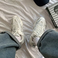 Casual breathable sports shoes with a lace-up front, round toe, and rubber sole in a solid colour.