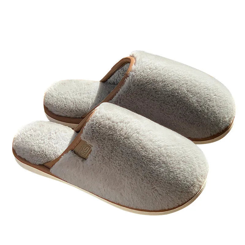 Blue plush PVC winter slipper with non-slip sole and car stitching detail on a wooden floor.