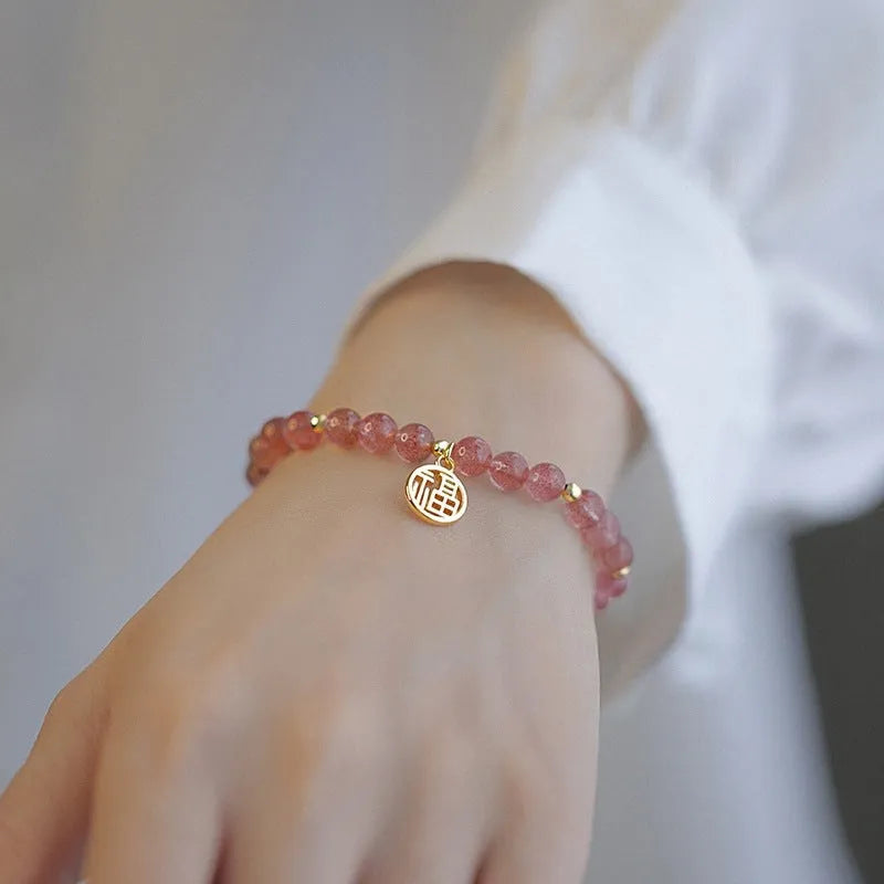 Strawberry quartz glass blessing card bracelet with adjustable clasp on wrist