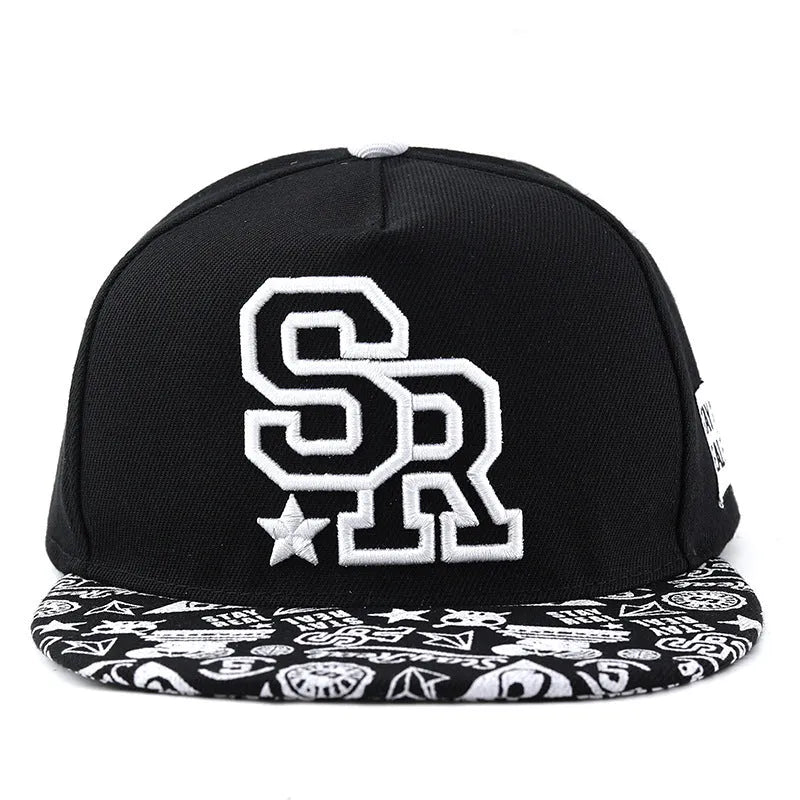 Black and white cotton baseball cap with embroidered letter design on the front.