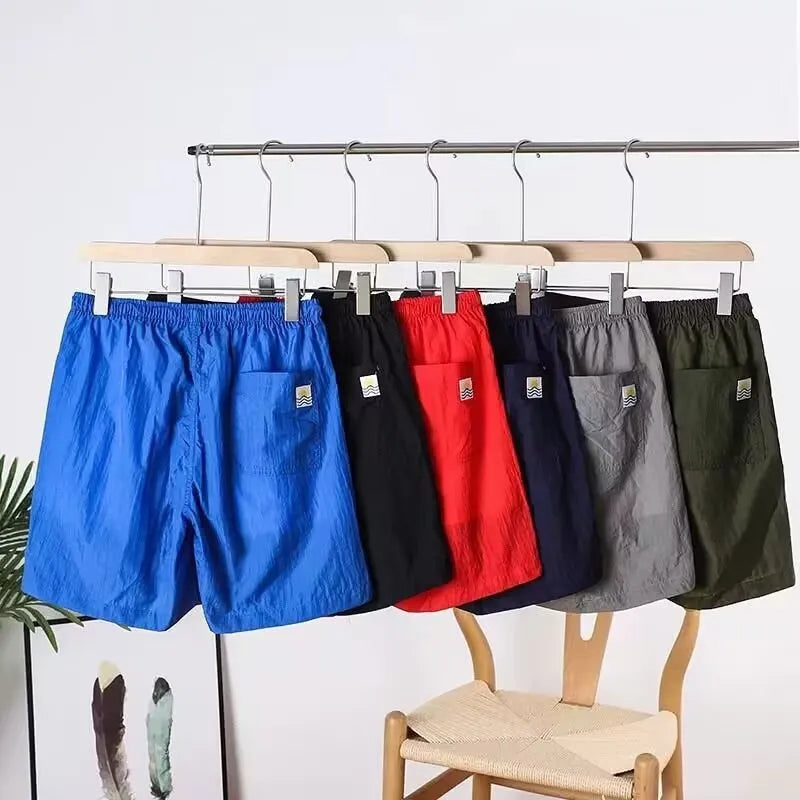 Men's straight-leg quick-dry sports shorts in army green on a plain background.