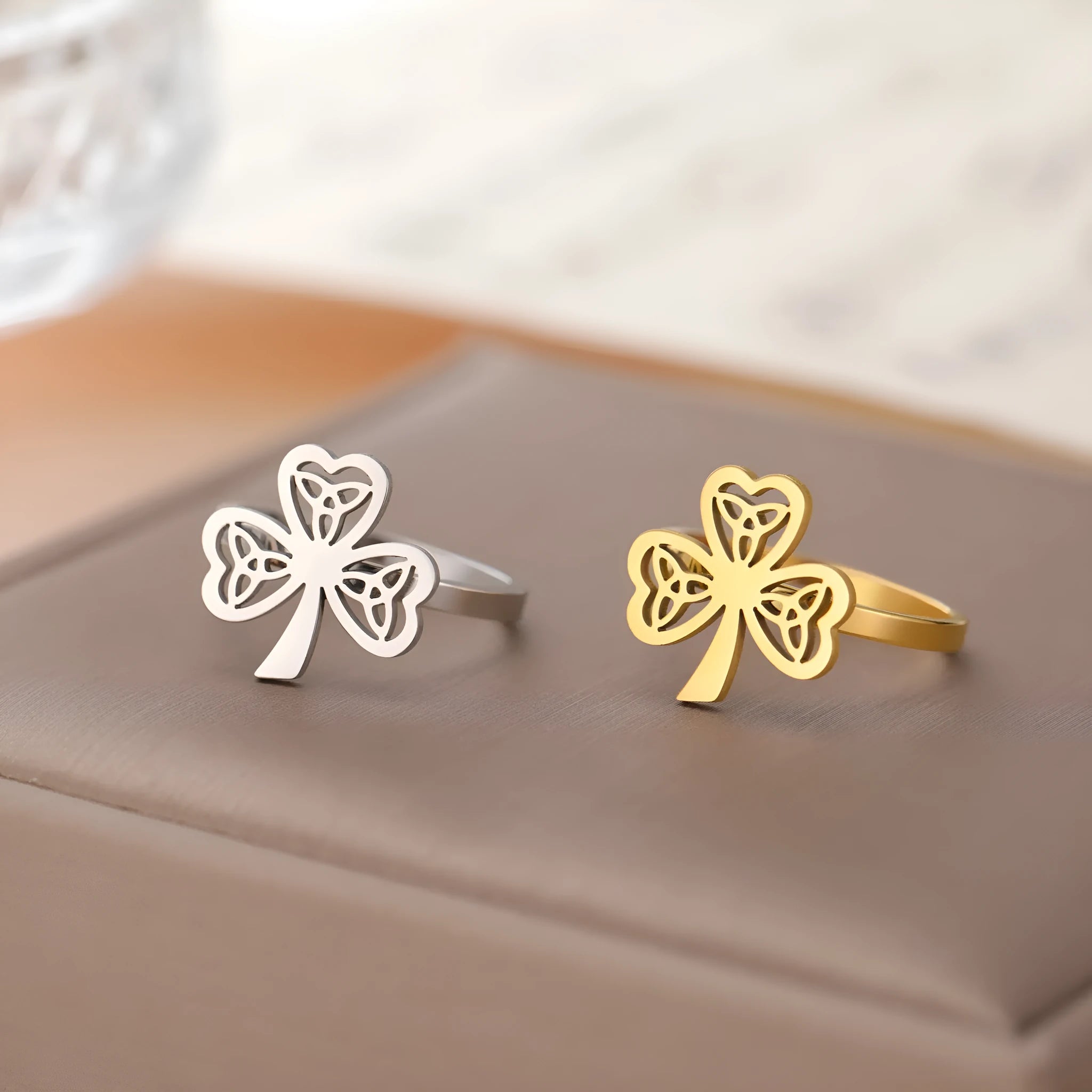 Women's hollow stainless steel fashion ring in gold or steel colour on a size chart.