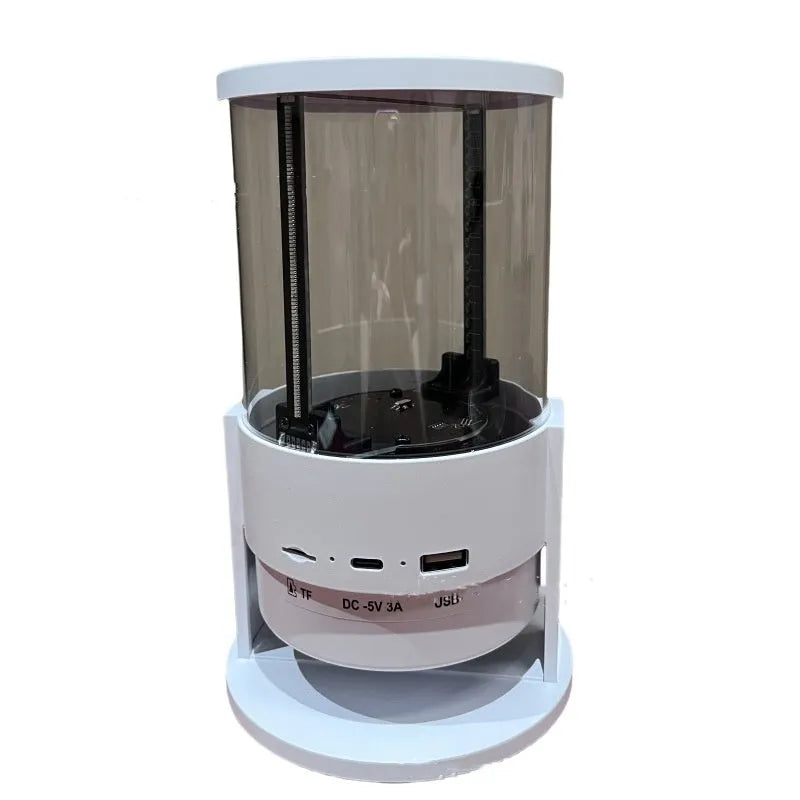 White 360-degree 3D holographic fan Bluetooth speaker with cylindrical screen on a desk