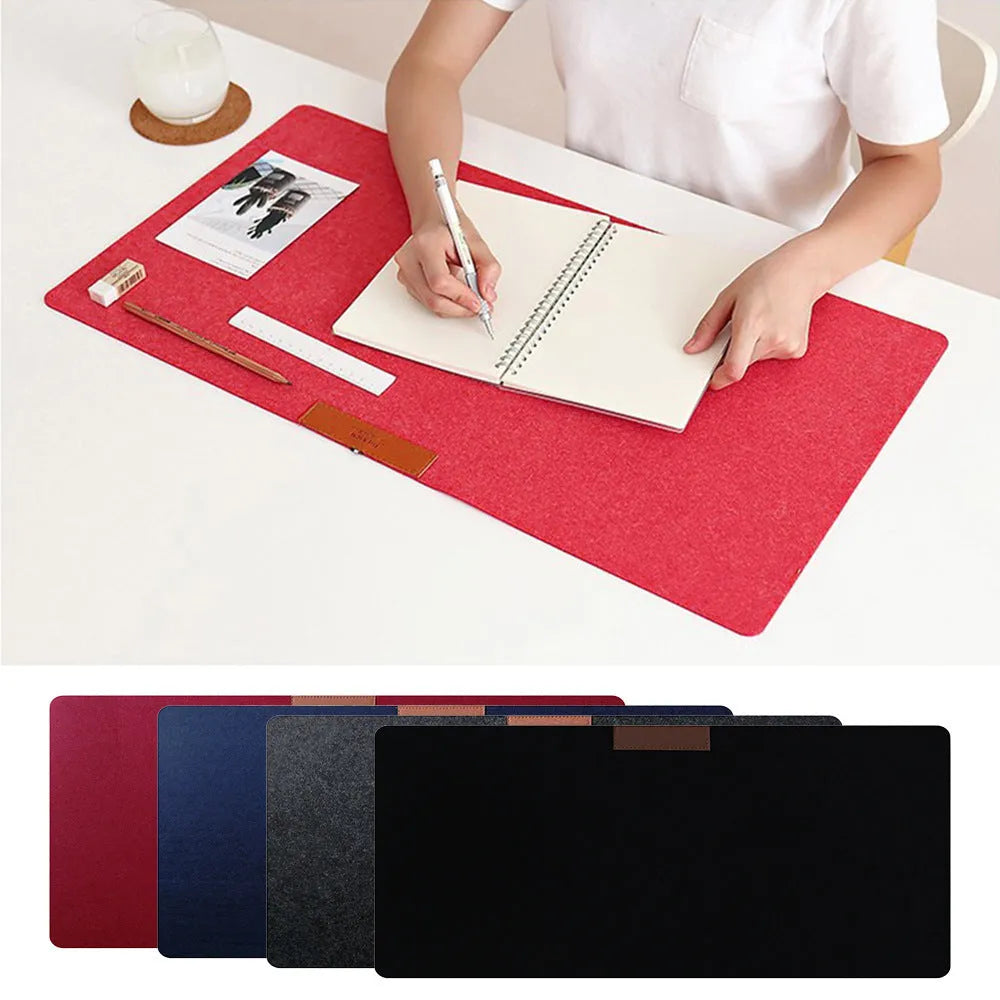 Large black felt desk mat with sewn edges, measuring 325x635mm, on an office desk with a keyboard and mouse.