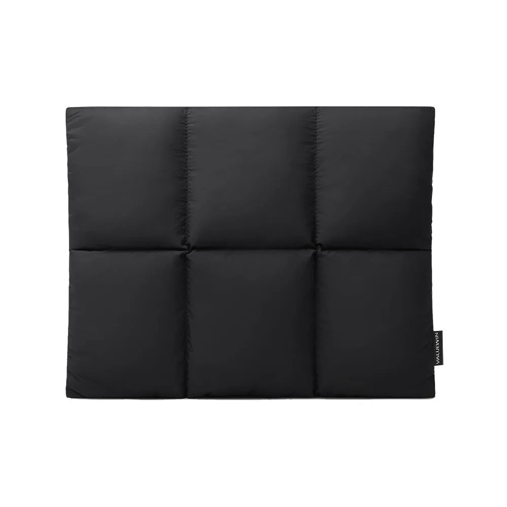 Soft fluffy polyester laptop sleeve in black with visible sewing thread detail, shown next to a laptop.