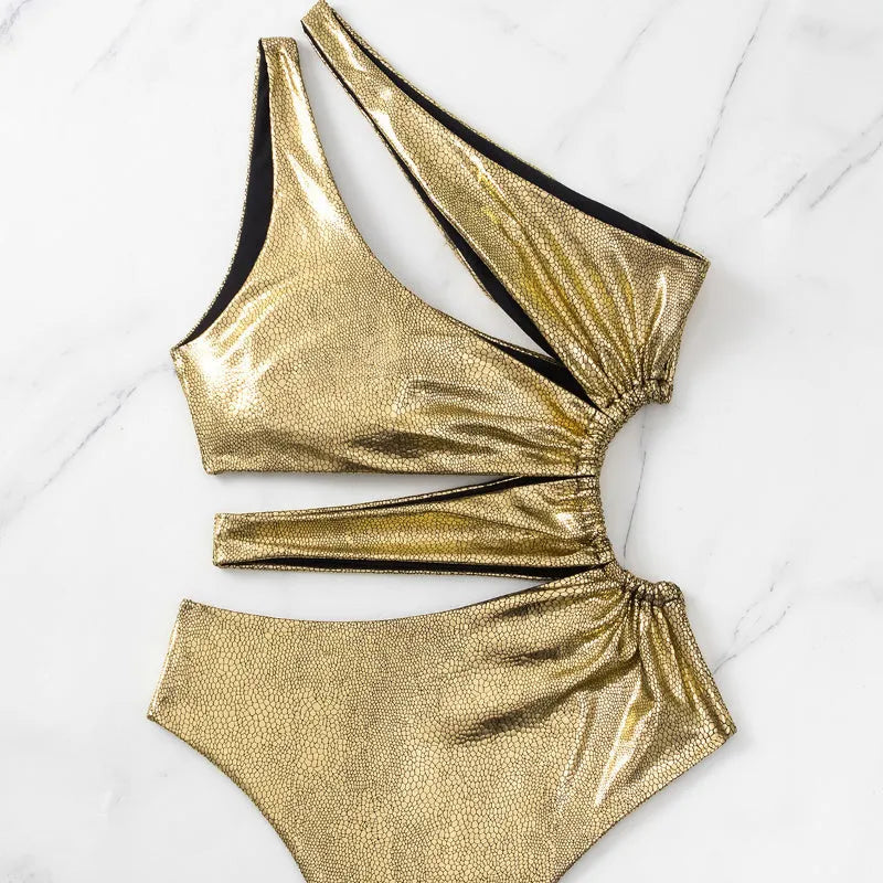 Women's gold backless one-piece swimsuit with spandex lining on mannequin