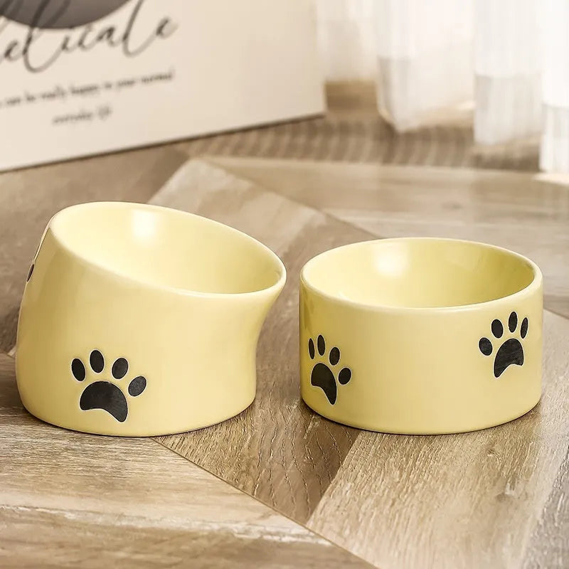 Ceramic cat bowl with high foot design and oblique mouth in cat's paw pattern
