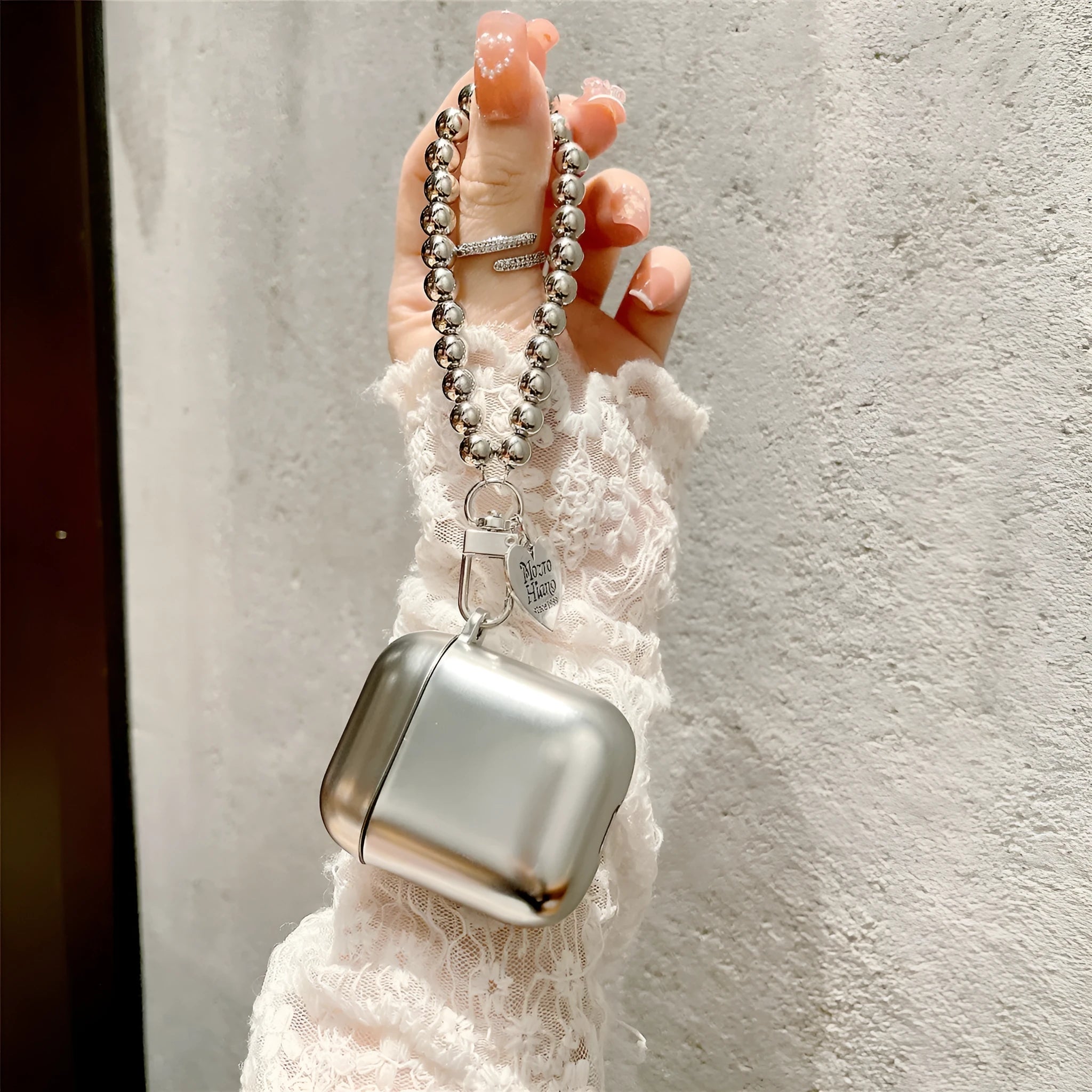 Matte plating AirPods protective case with electroplated detailing and bracelet element