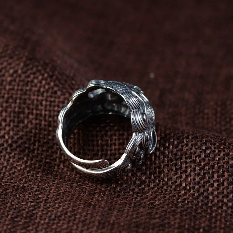 Silver open ring with jibeast pattern and diamond accents showing zodiac animal design