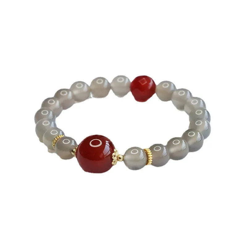 Smoky purple chalcedony red agate bracelet with 8mm geometric beads on a wrist.