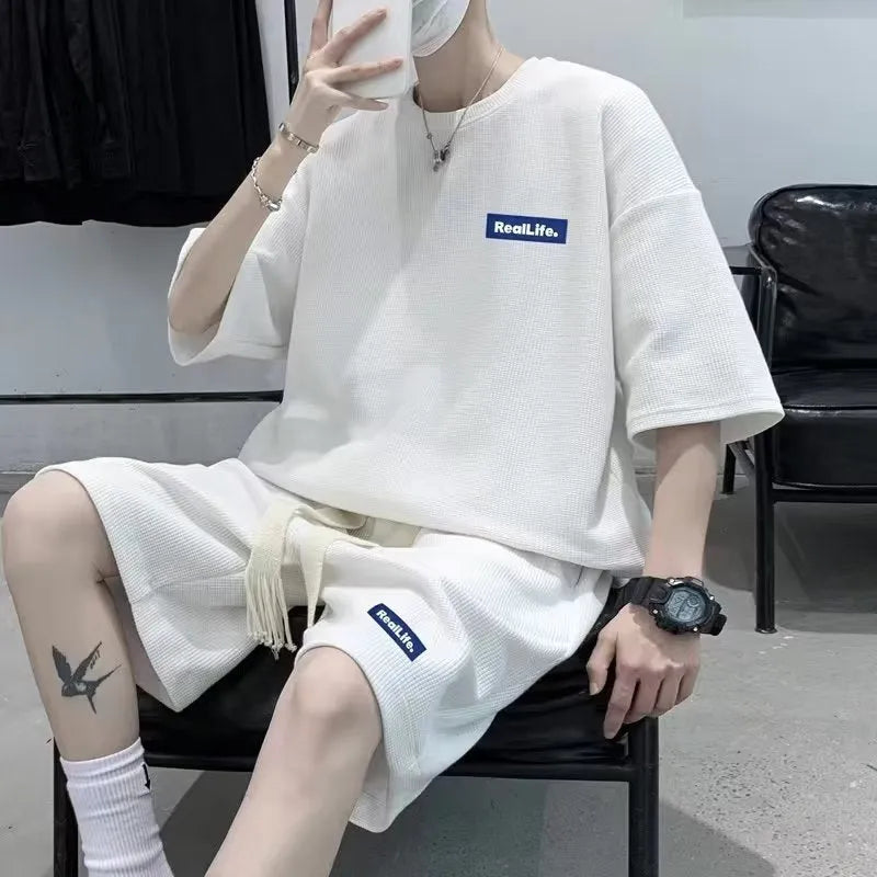 Men's cotton polyester waffle texture short sleeve top and shorts leisure sports suit set on a hanger.