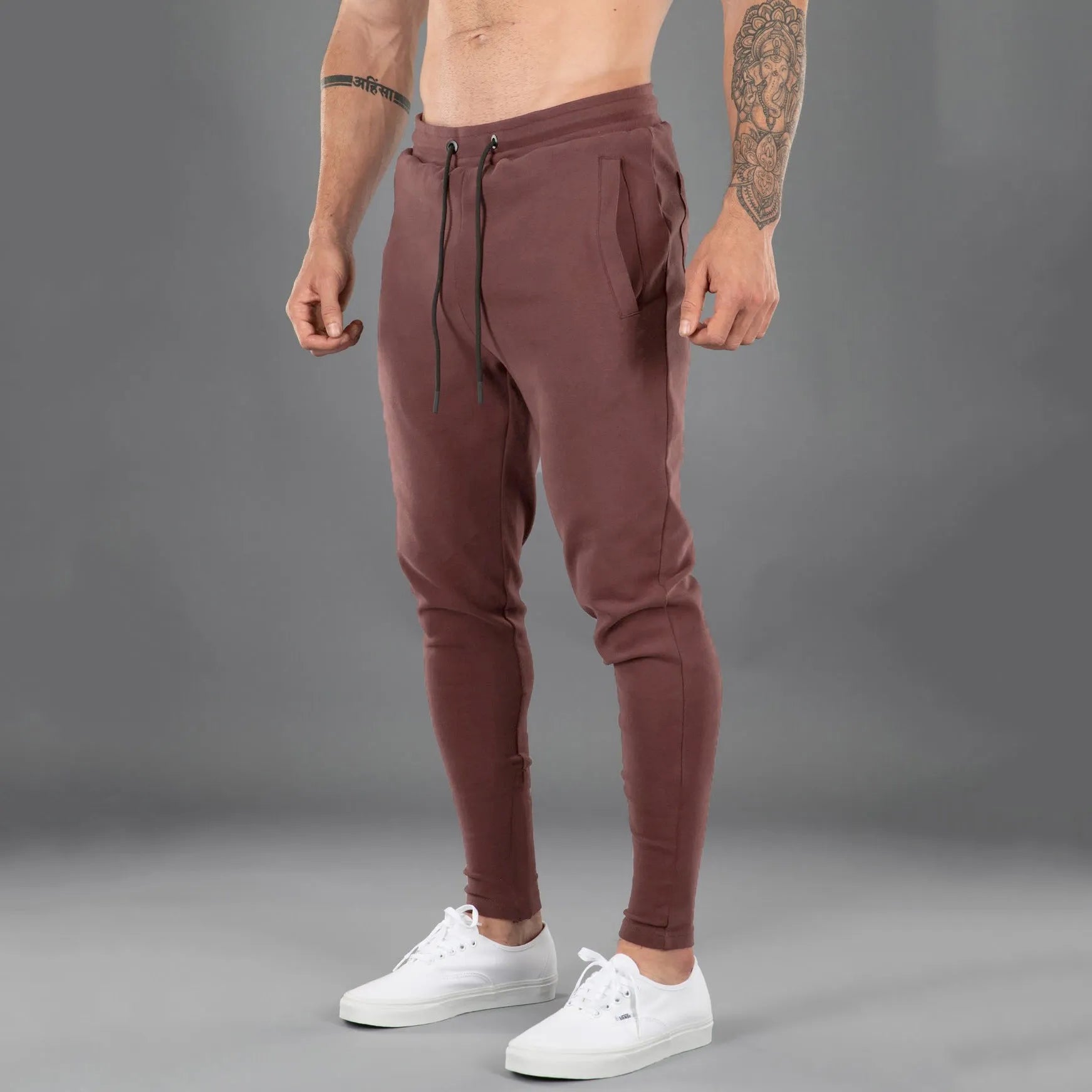 Men's cotton skinny stretch sports pants in black with moisture wicking fabric, middle waist design