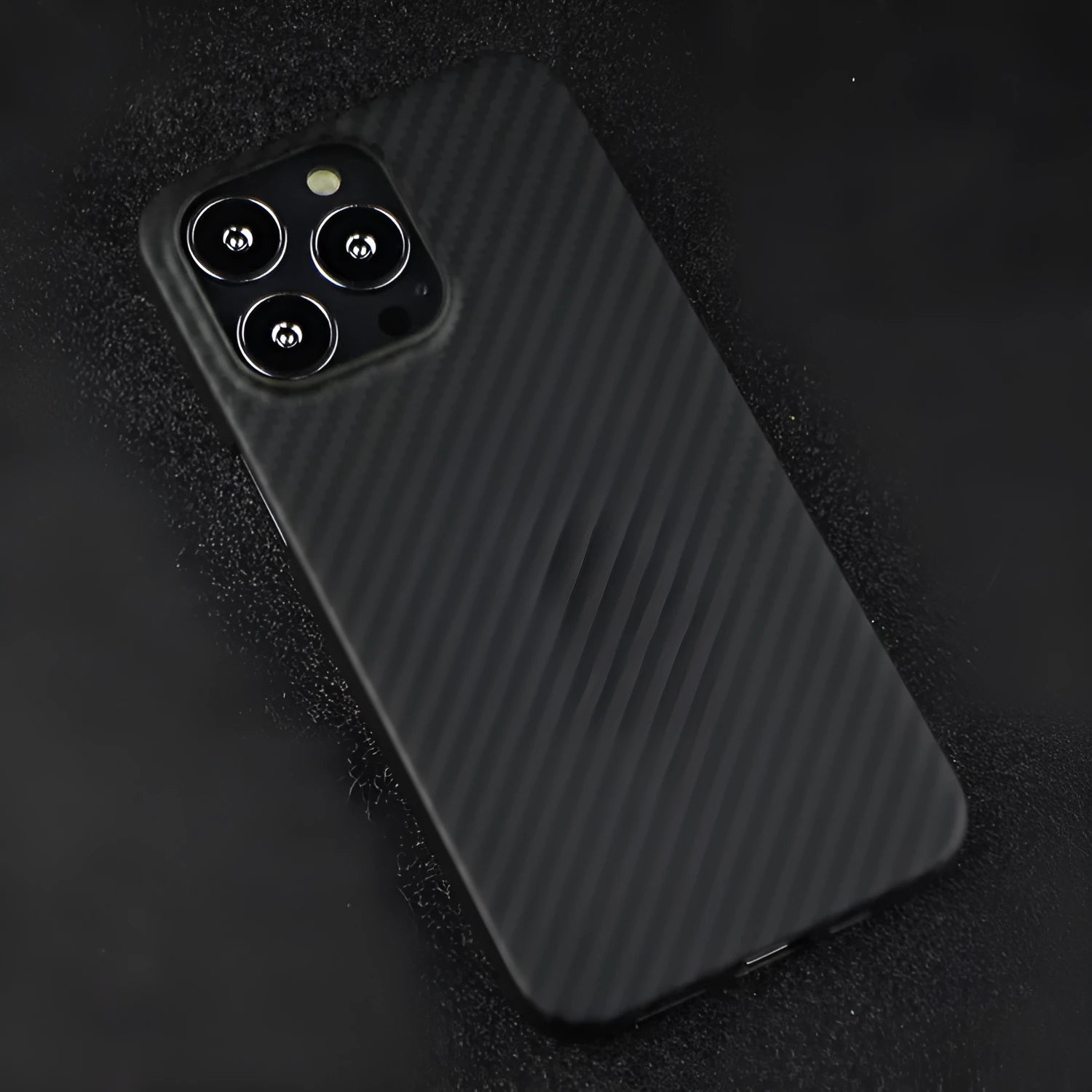 Dull black kevlar fibre iPhone case with volcanic crater texture and MagSafe ring
