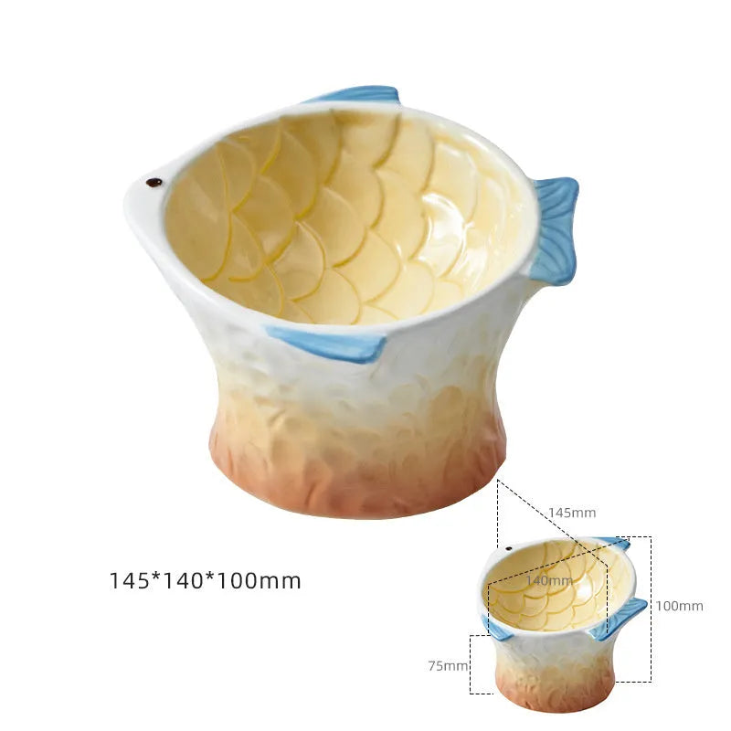 Set of four blue, fish-shaped ceramic cat bowls with a tilted design on a kitchen counter.