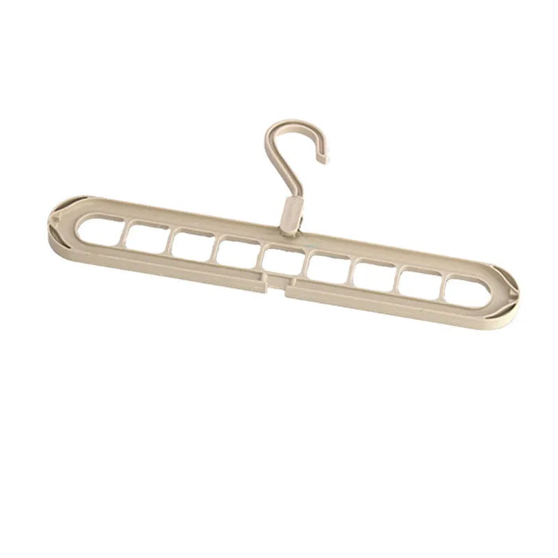 Nine-hole plastic trousers hanger in green colour showing folded pant rack functionality