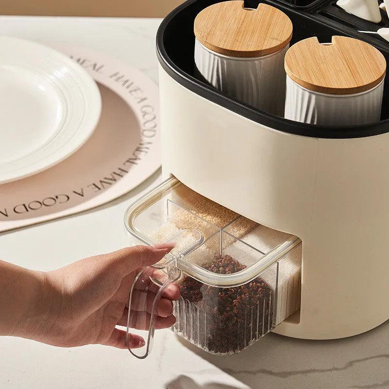 White rotating kitchen storage bucket and four-compartment spice box organiser for cutlery and seasonings.