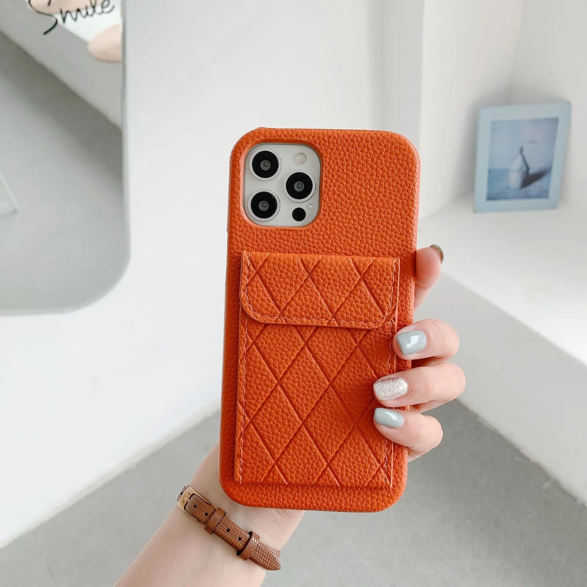 Tide Brand black imitation leather phone case with card slot for iPhone, shown next to credit cards.