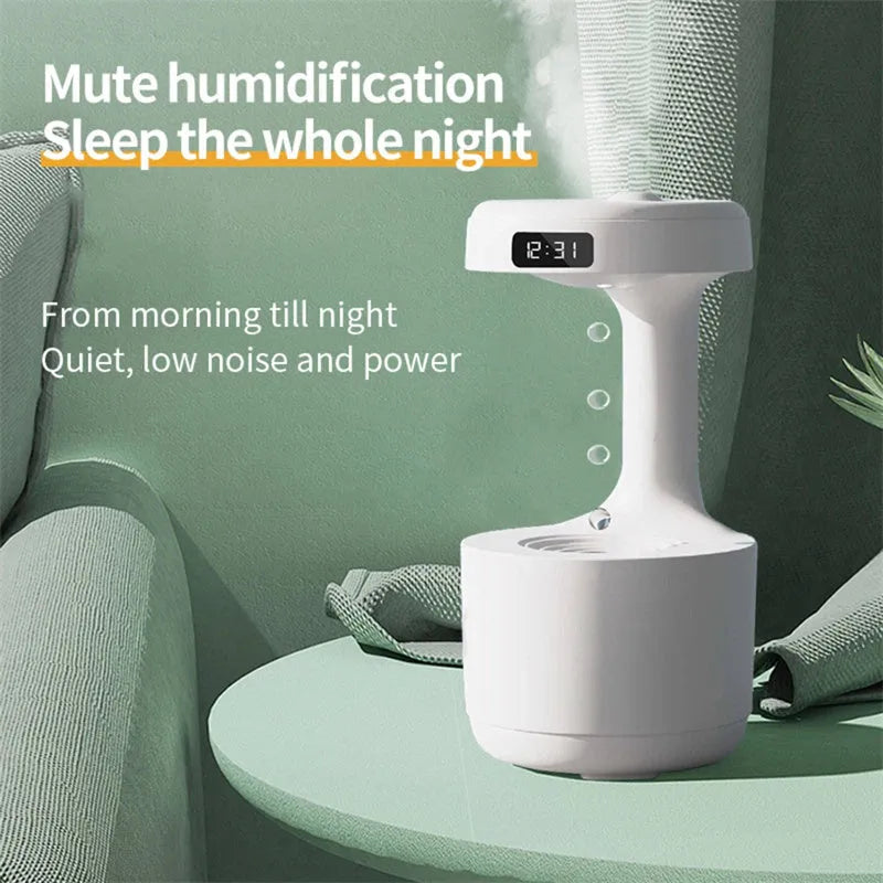 White columnar anti-gravity humidifier with LED clock display emitting mist on a wooden desk.