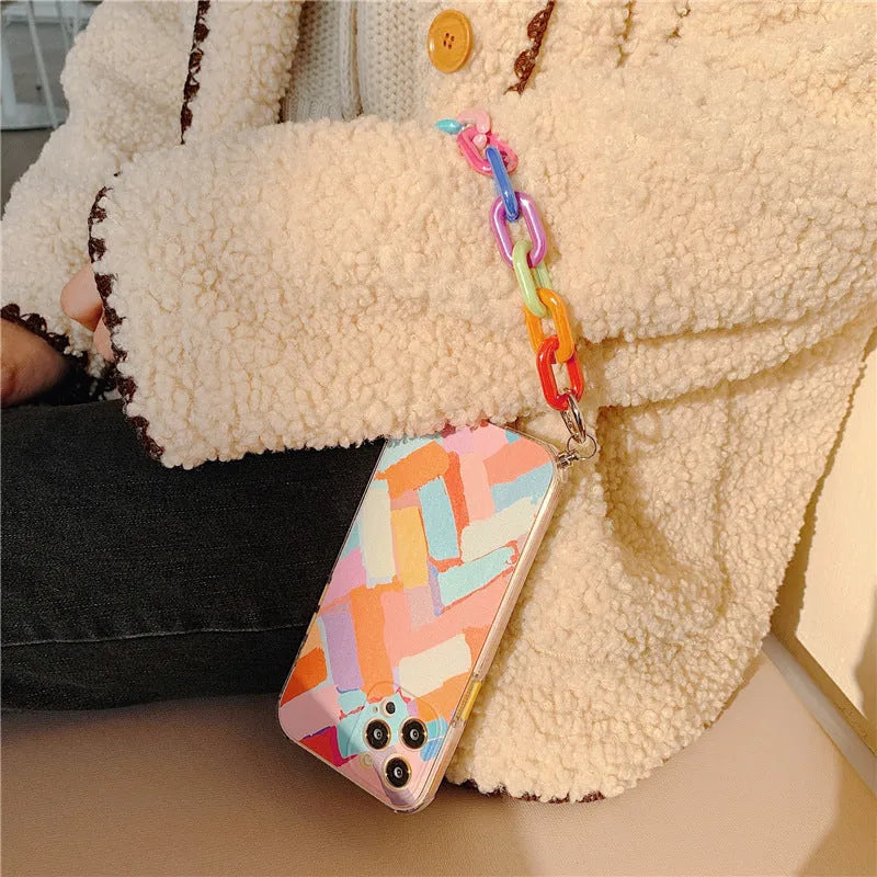 Pink graffiti design mobile phone case with an integrated wrist strap for iPhone.