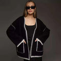 Loose mid-length knitted cardigan with lace-up front, in white, black, or camel.