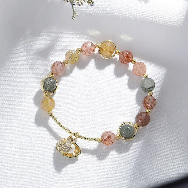 Women's crystal bracelet with coloured hair crystal shells and red sealant flower shells on wrist