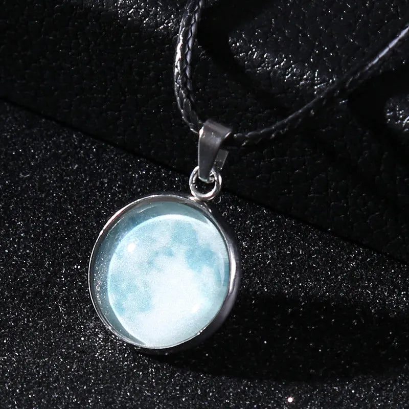 Luminous moon and constellation glass pendant on a silver alloy necklace chain with an extension piece.