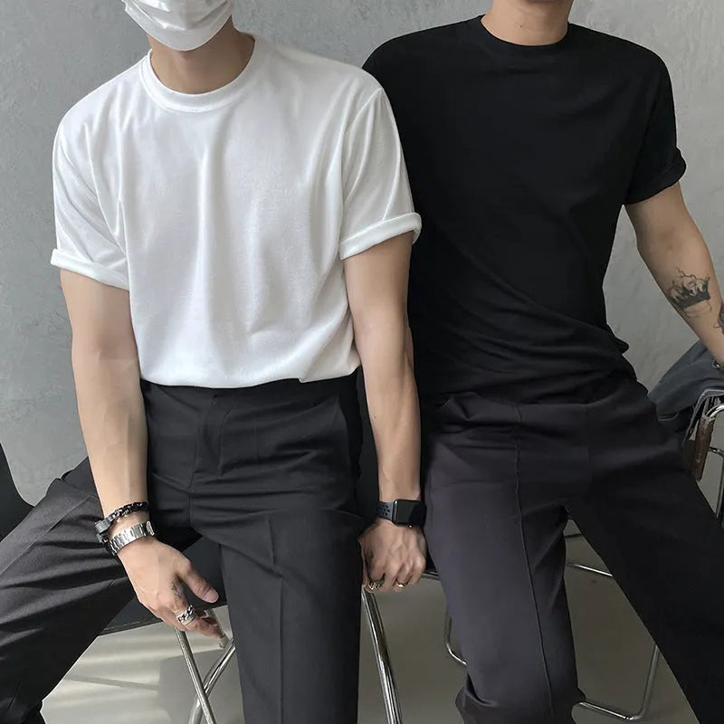 Men's slim fit black cotton t-shirt with round neck and half sleeves on a model.