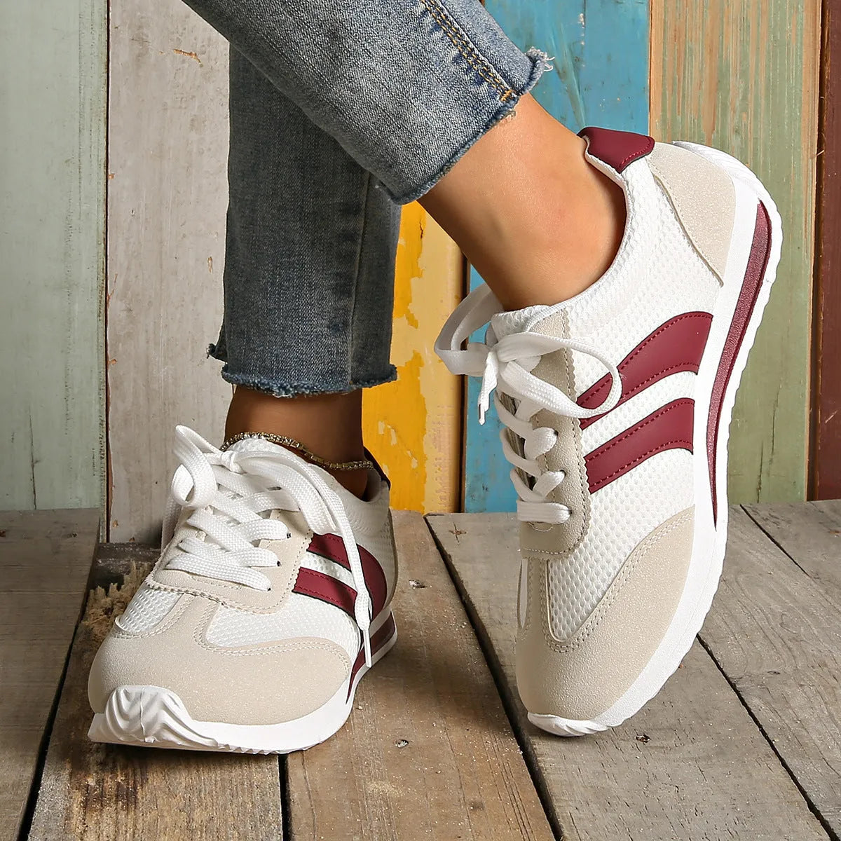 Wine red Cortez Retro low-top sneakers with a cross-strap and breathable mesh panels.