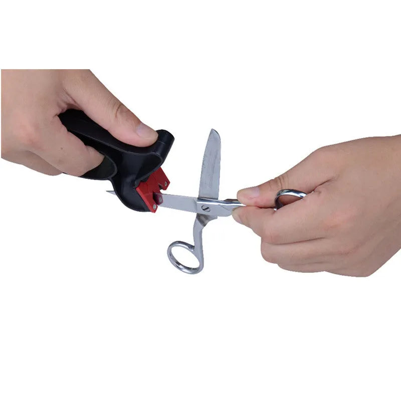 Black handheld knife and scissor sharpener showing ergonomic handle and sharpening slots on a white background.