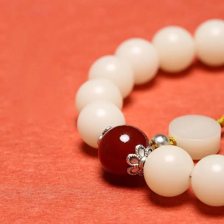 White jade Bodhi bracelet with round 10mm beads, ruyi decoration, shown in obsidian, red agate and red code brain colour variants