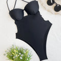 Black solid colour one-piece swimsuit for women on a mannequin, showing the one-piece spandex design.