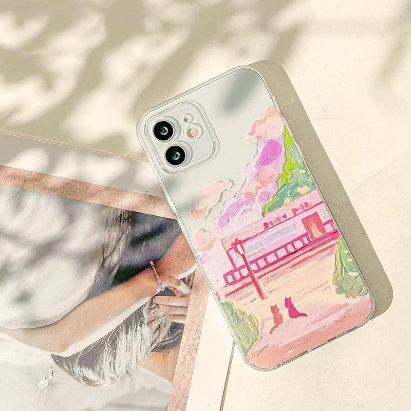 Soft silicone iPhone case with a cartoon design of two cats on the back.
