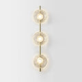 Decorative bedside wall lamp with a glass art shade on an iron base, showing light colour options.