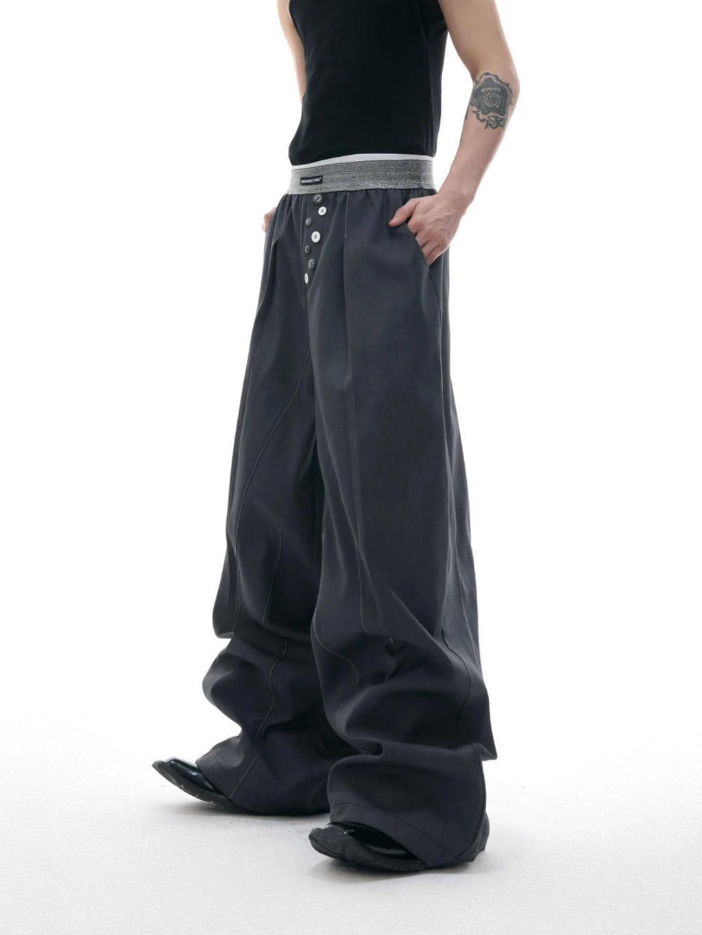 A pair of high-waisted straight-leg casual trousers in grey with a button fly front.