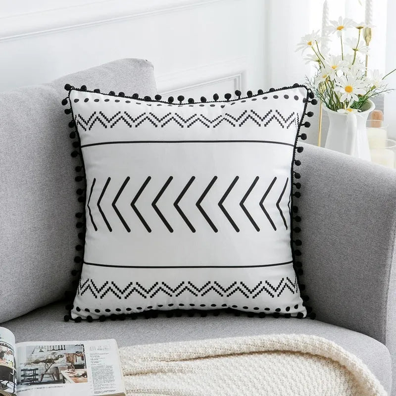 Bohemian national style throw pillow cushion cover in light grey on a sofa.