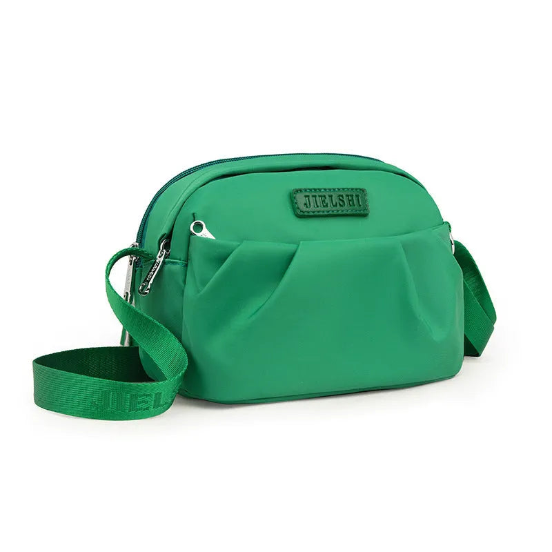Pleated Oxford cloth crossbody messenger bag in a horizontal square shape with a phone compartment.