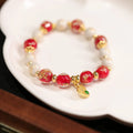 Women's ethnic bracelet with gold foil coloured glaze geometric design in pink or red colour options