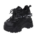 White women's platform sports shoes with mesh upper, cross strap, and a thick rubber sole.