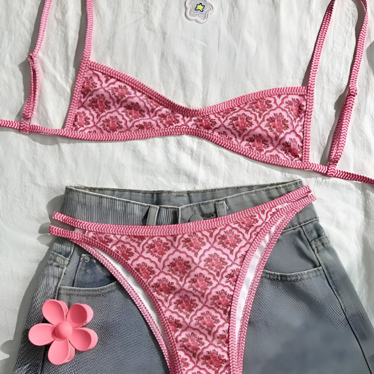 Pink printed two-piece bikini set with shoulder straps and exposed back cut-out for ladies