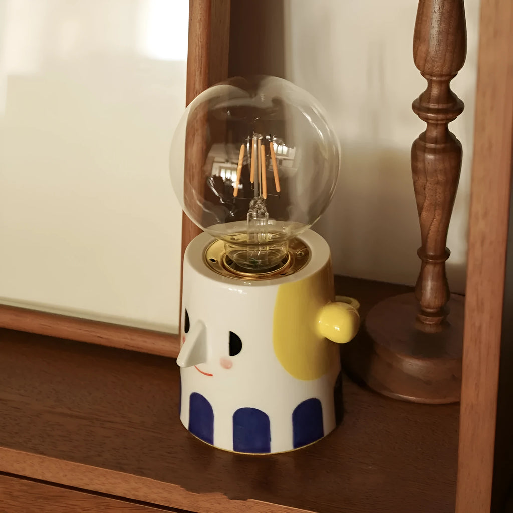 Handmade ceramic table lamp with a spherical ball headlight design on a solid ceramic base.