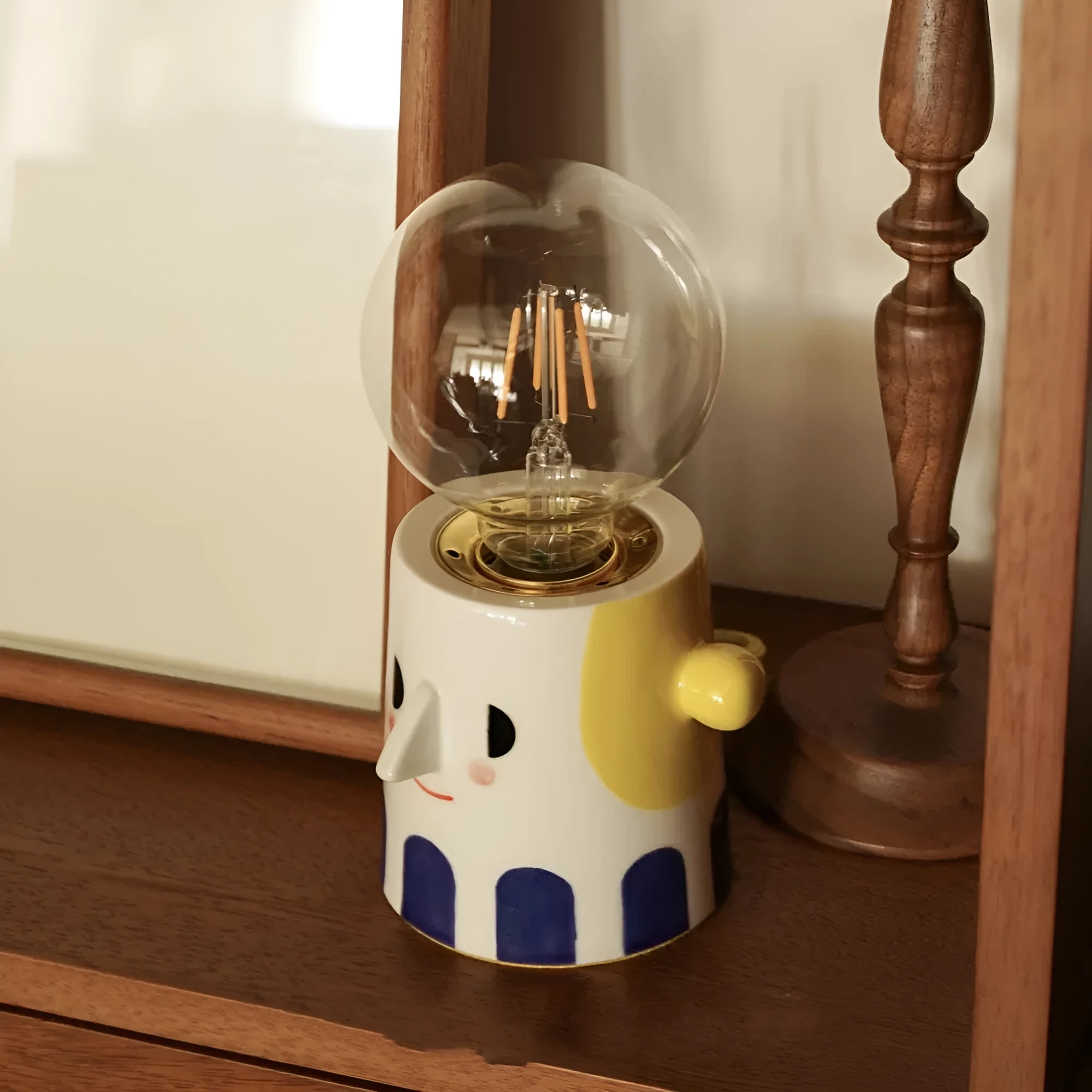 Handmade ceramic table lamp with a spherical ball headlight design on a solid ceramic base.
