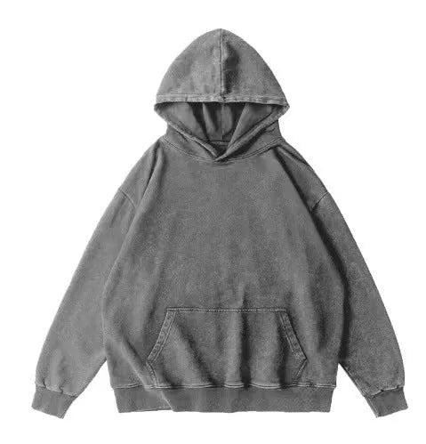Man wearing a loose, brown batik-washed cotton hoodie with drop shoulder sleeves.