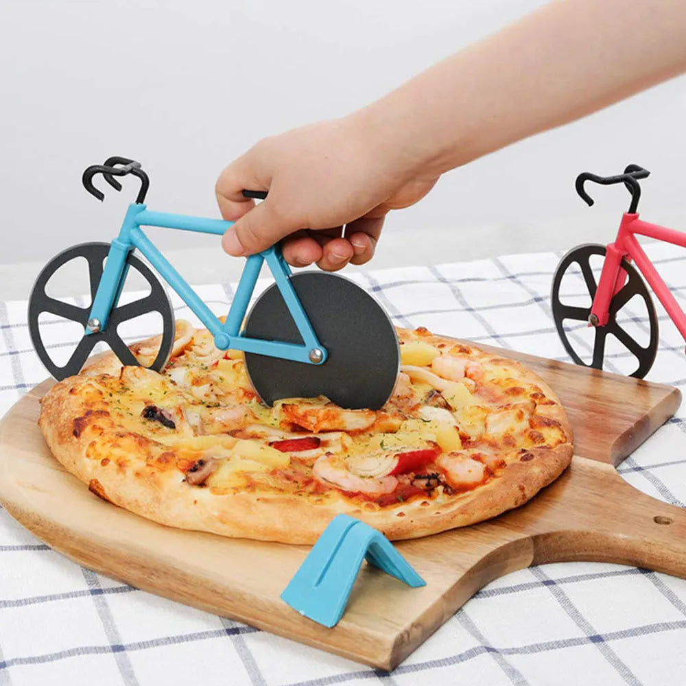Bicycle-shaped pizza cutter with stainless steel blade and hand-grip handle on a cutting board