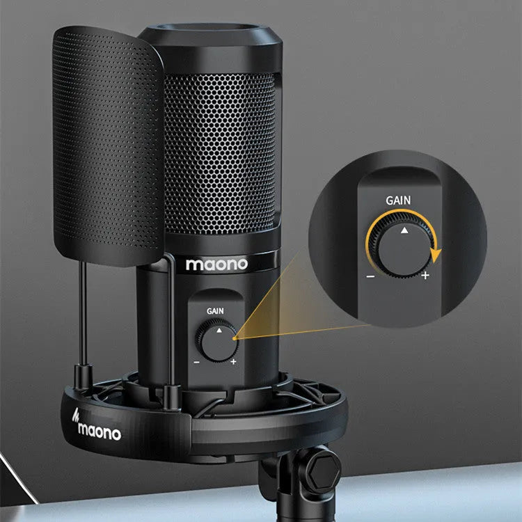 USB recording microphone with shock mount and tripod on a desk for computer or phone dubbing.