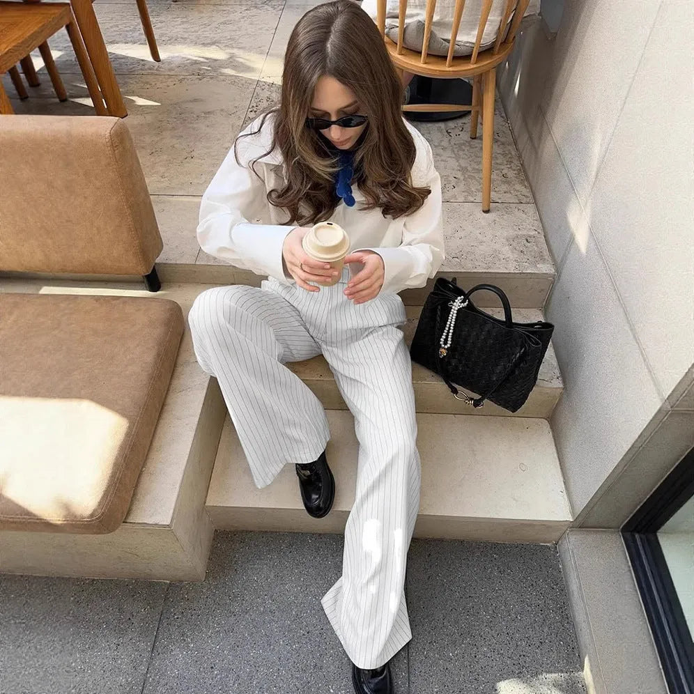 White striped wide-leg casual trousers with a loose fit and zipper detail on a mannequin.