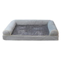 Square sponge dog bed in blue cloth, showing its raised breathable design on a wooden floor.