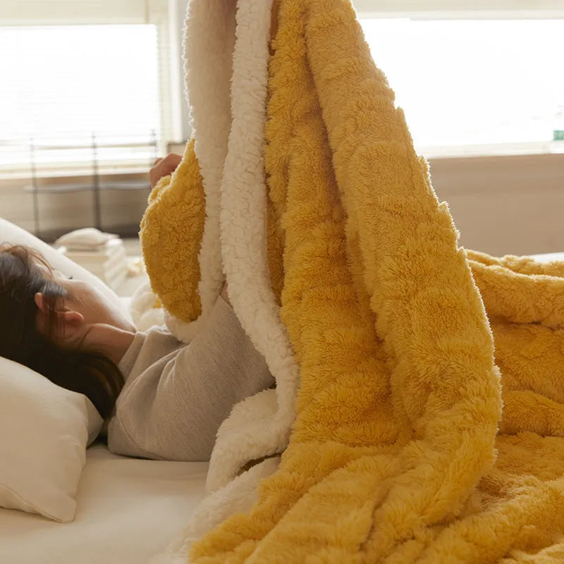 Taffeta thermal flannel winter blanket in beige draped over a modern sofa.