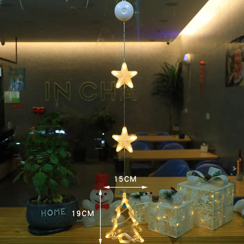 Three Christmas LED light ornaments with suction cups hanging on window