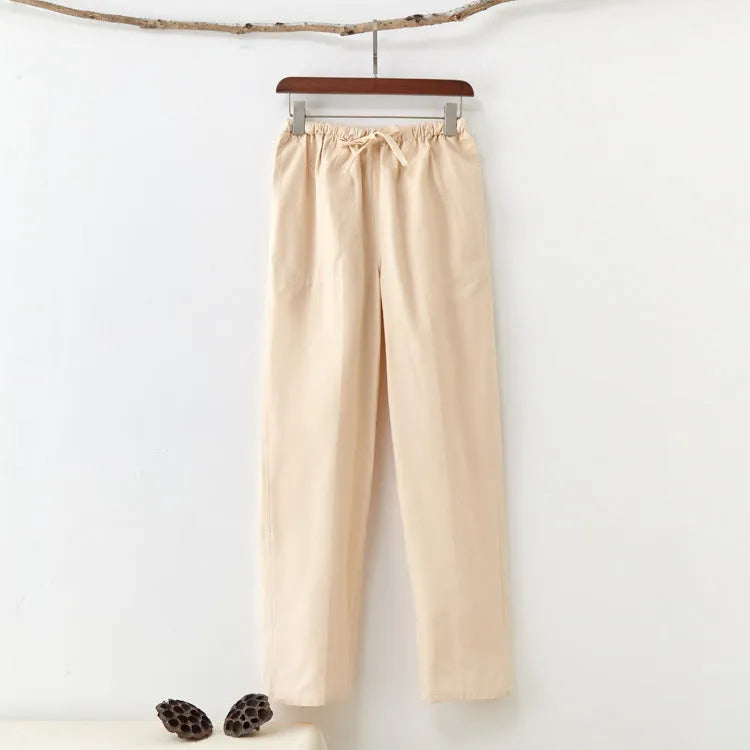 Men's beige pure cotton casual trousers with a drawstring waist on a mid-rise fit.