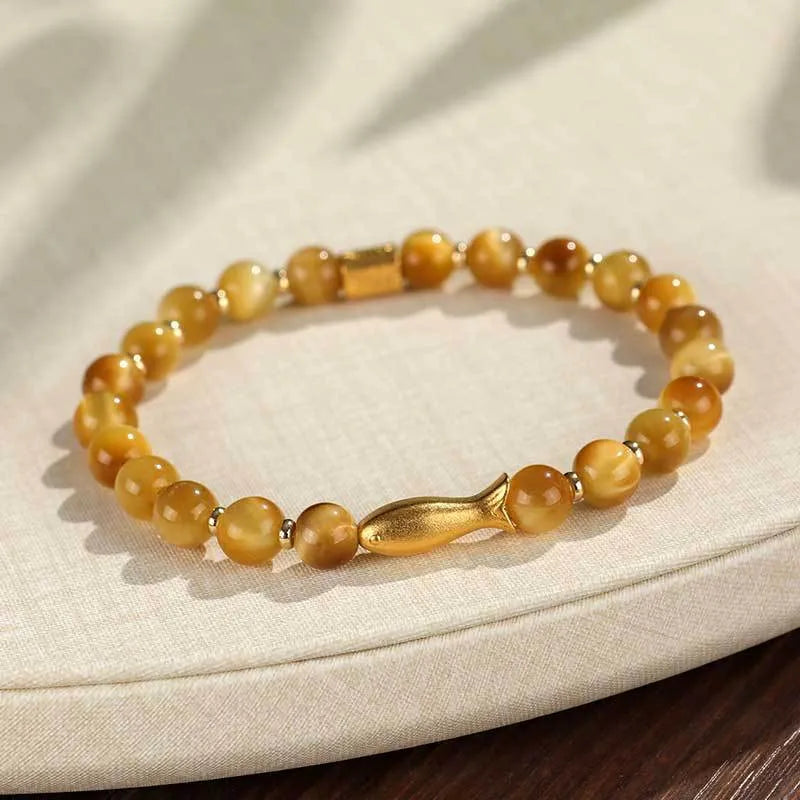 Handmade women's bracelet with tiger eye gemstone beads carved into small fish designs